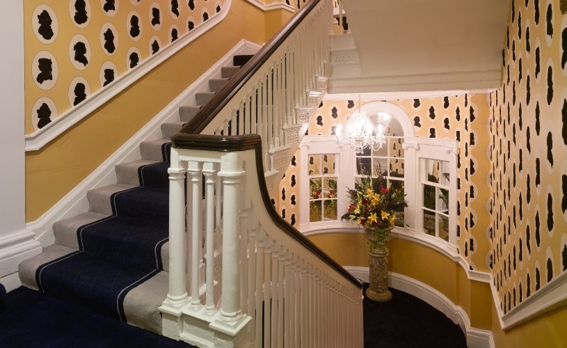Stairwell with Regency-inspired decor at Francis Hotel